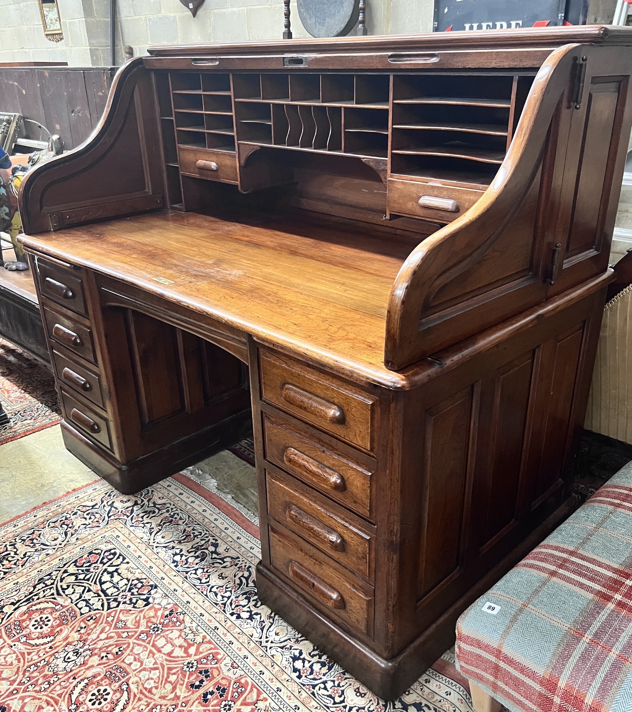 An early 20th century walnut roll top desk with 'S' shaped tambour, width 152cm, depth 84cm, height 128cm